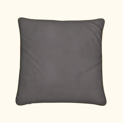 Gray pillow with gold trim on a black background