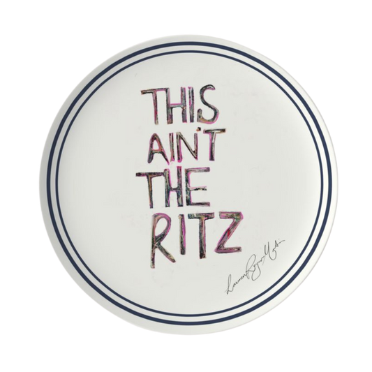 Round white plate with 'This ain't the Ritz' text in colorful letters on a white background